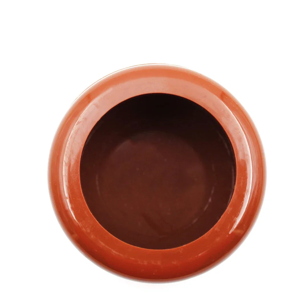 Top view of a round empty brown plastic grit pot on a white background