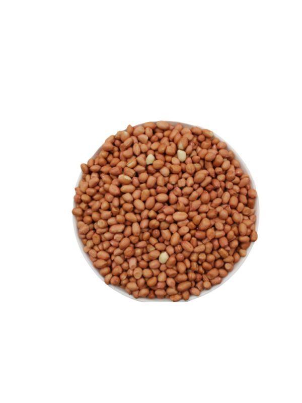 Top view of a bowl filled with raw brown peanuts on a white background