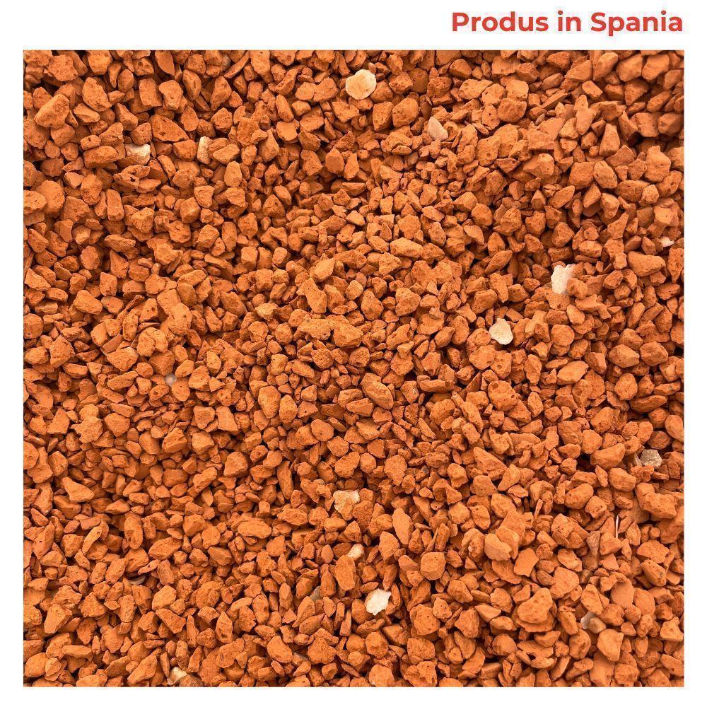 close-up of red brick grit for pigeons with some white grit pieces, produced in Spain