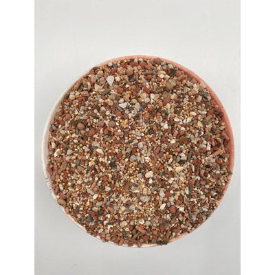 Top view of a bowl filled with mixed natural minerals and small pebbles