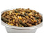 Close-up of mixed animal feed pellets with grains and seeds in a stainless steel bowl