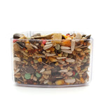 Clear container filled with mixed bird seeds and dried fruits including sunflower seeds, corn, and pellets