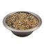 Metal bowl filled with mixed bird seed including sunflower seeds and millet for pet birds