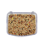 Clear plastic bird feeder filled with premium mixed bird seeds on white background