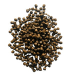 Pile of small dark brown fish food pellets on a white background