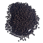 Pile of small dark brown fish food pellets on white background