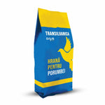 Blue and yellow bag of Transilvanica pigeon food with a dove graphic and Dalıs Impex branding