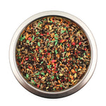 Top view of a stainless steel bowl filled with colorful bird seed mix for pet birds
