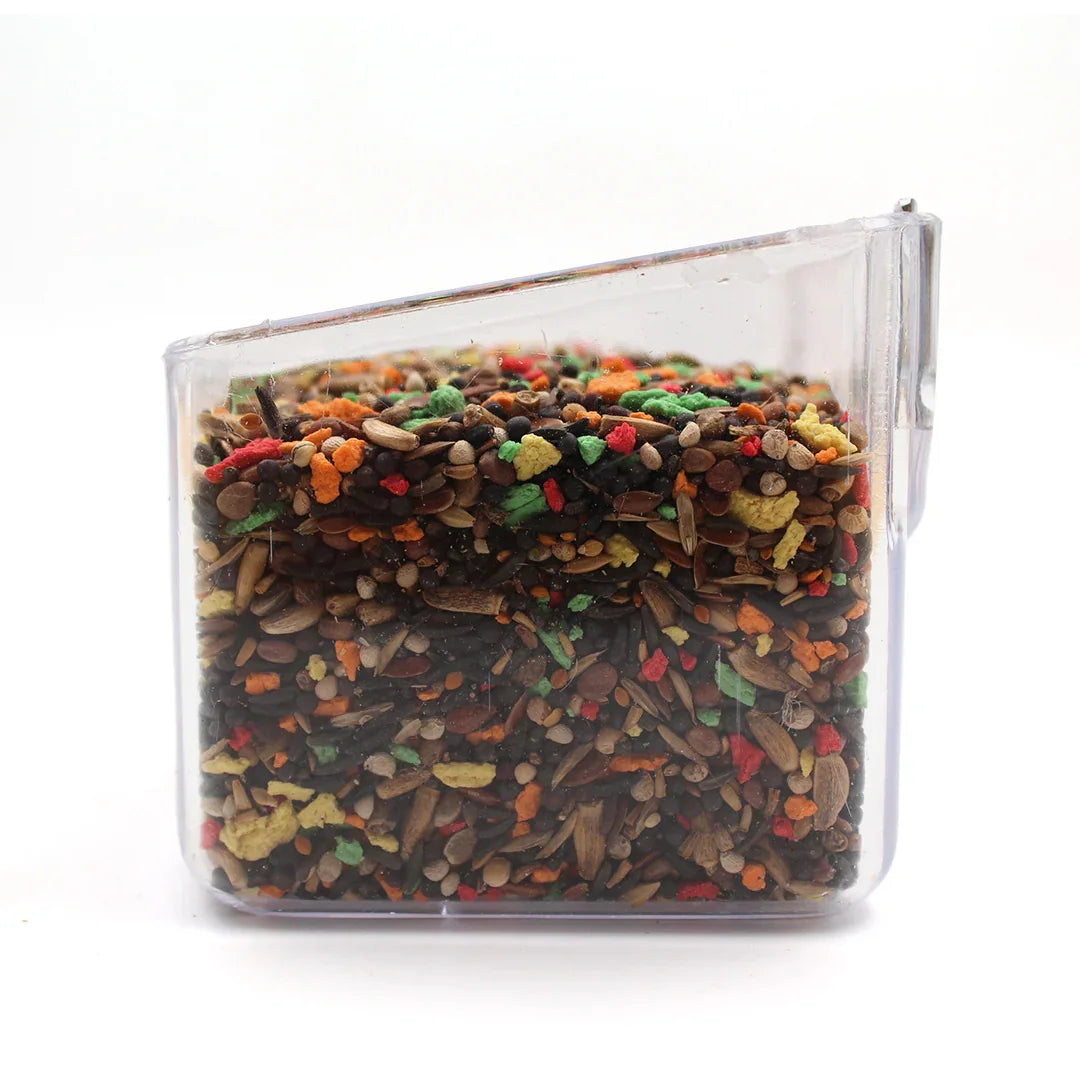Clear plastic container filled with colorful birdseed mix including seeds and pellets
