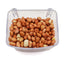 Clear plastic container filled with raw shelled peanuts on a white background