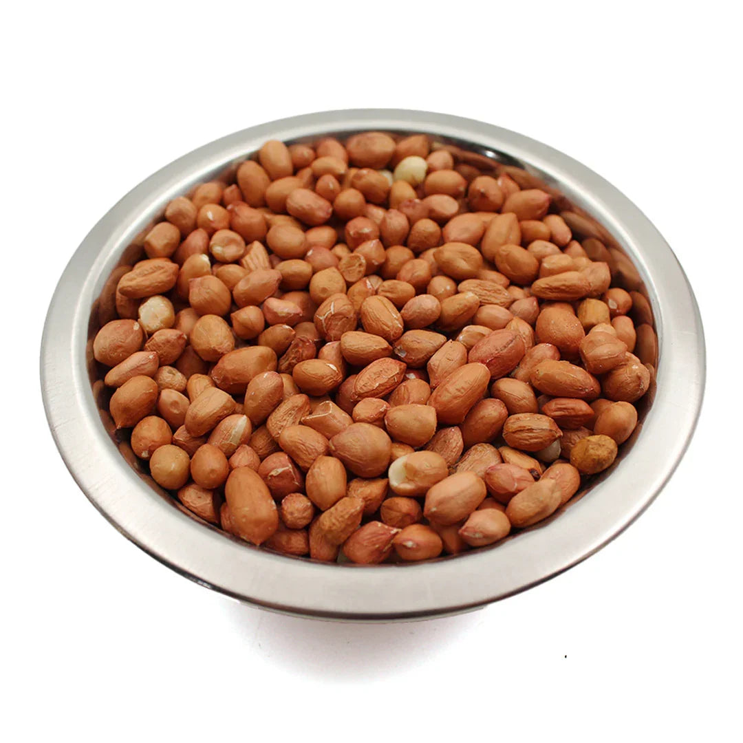 Raw peanuts with skin in a stainless steel bowl on white background