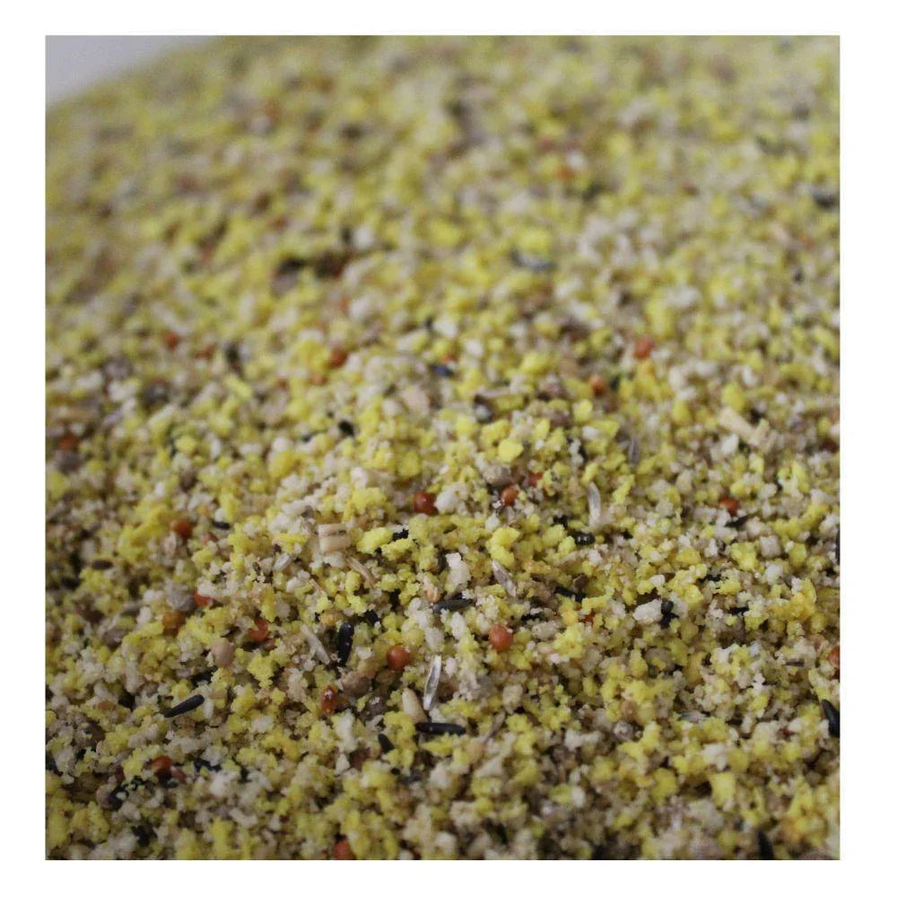 Close-up of yellow and mixed grains bird feed for pigeons with seeds and pellets