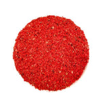 Top view of coarse red spice or seasoning granules on white background