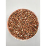 Bowl filled with mineral and soil granular mix in various shades of brown and beige