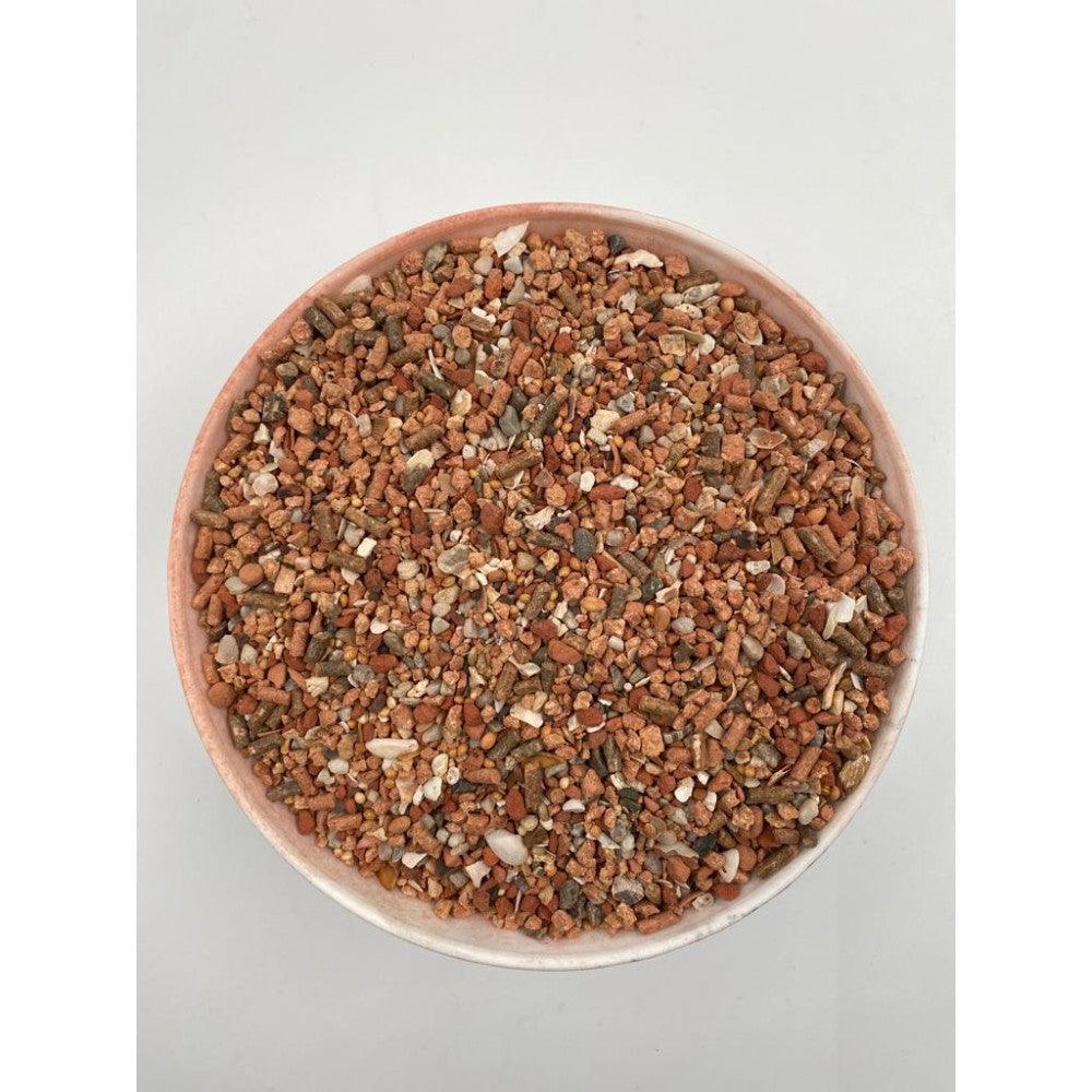 Bowl filled with mineral and soil granular mix in various shades of brown and beige