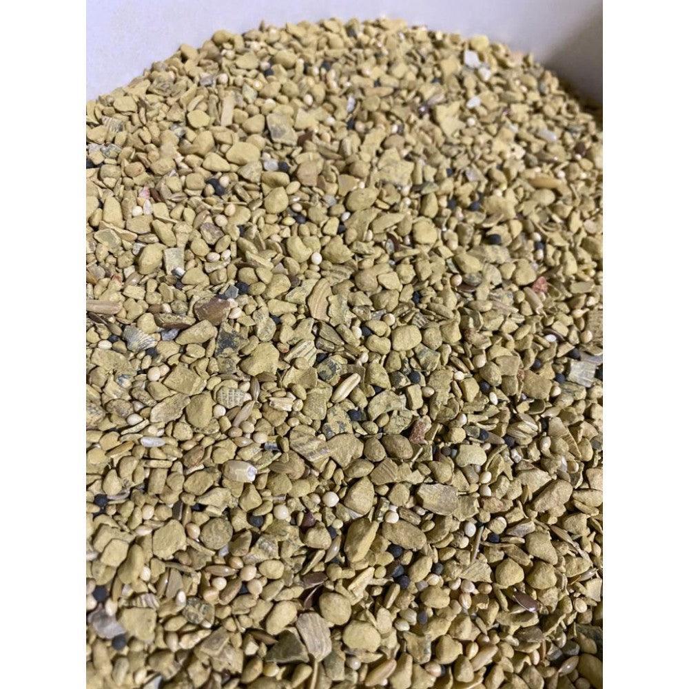 Close-up of mineral mix for animal feed with yellow granules and seeds in white container