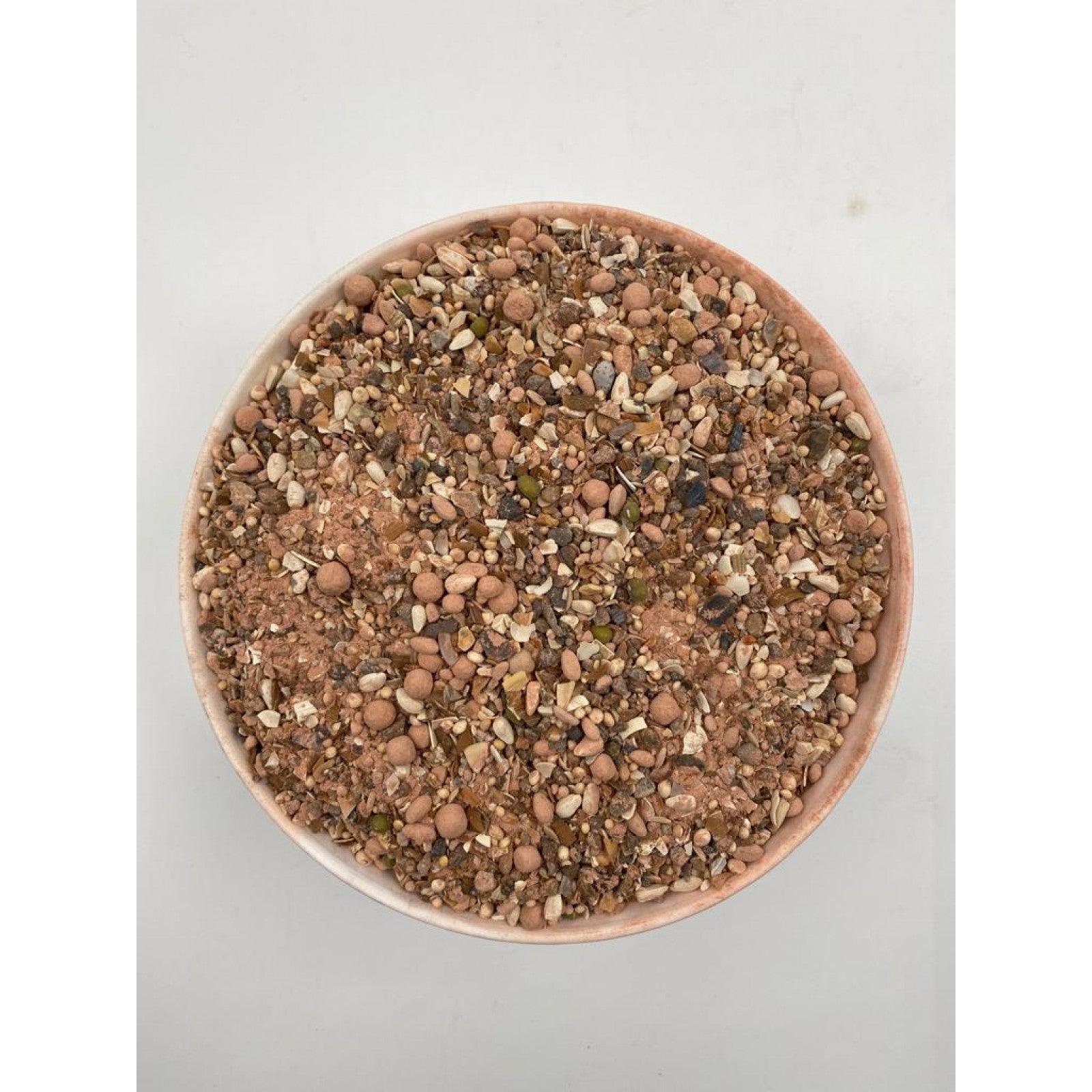Top view of a bowl filled with mineral paloma multi power mix feed with seeds and pellets