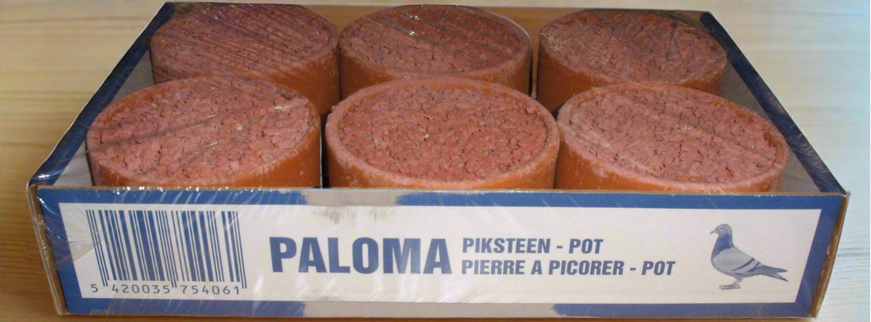 Paloma grit stone pots for pigeons packed in a blue and white box on wooden surface