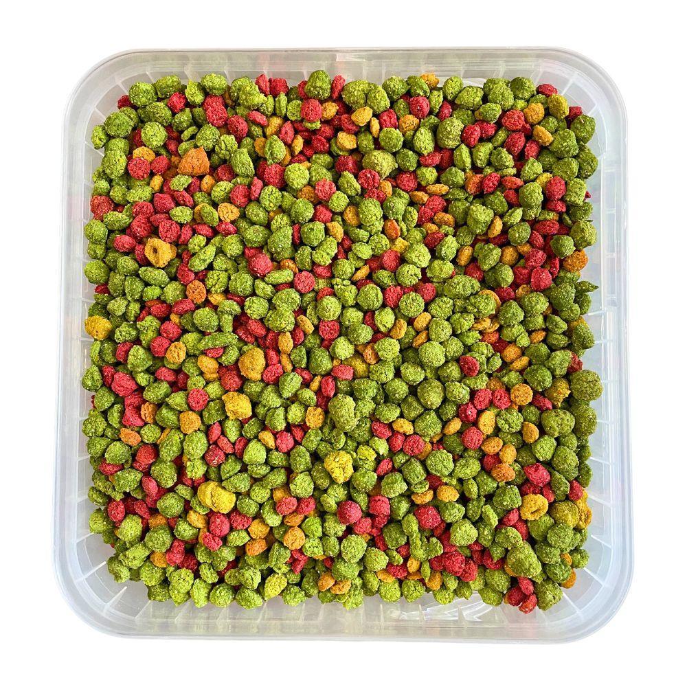 Colorful green, red, and orange bird pellets in a transparent square container for cockatiels and lovebirds