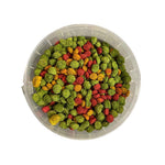 Plastic container with colorful green, red, and yellow pellets bird food for parakeets and lovebirds