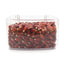 Close-up of dark red corn kernels packed in a transparent square container on white background