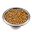 Metal bowl filled with yellow popcorn kernels on white background
