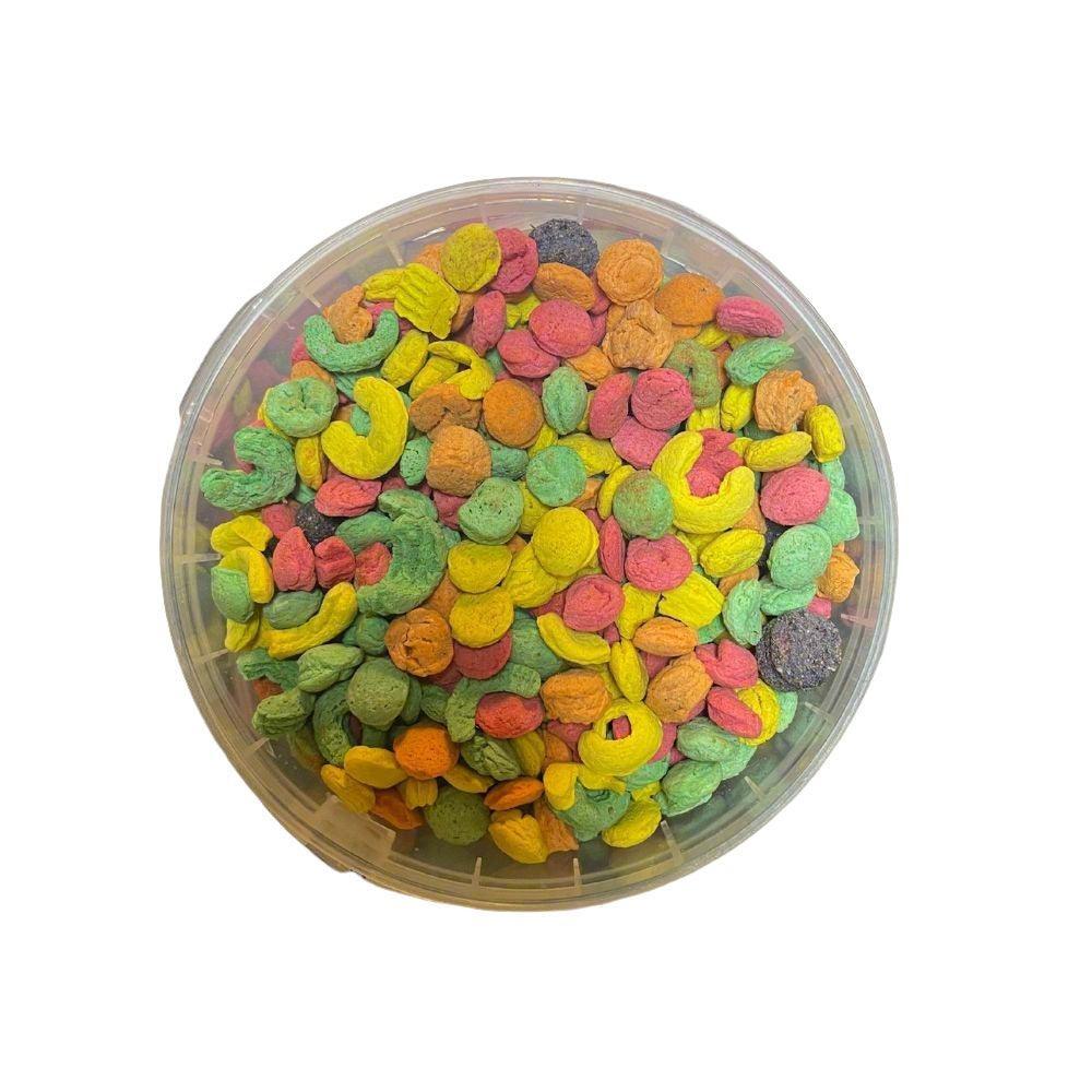 Colorful dry bird snack mix in a transparent round plastic container on white background